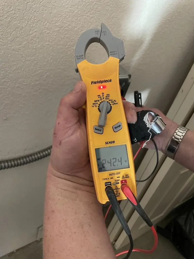 Voltage testing with clamp meter during Ceiling Fan Installation in Trumann